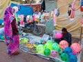 an indian shopkeeper filling air on balloon at street shop in india January 2020