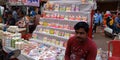 an indian shopkeeper seating at street shop selling statue during Hindu religious festival diwali in India