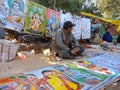 an indian shopkeeper selling posters at local fair events in india January 2020