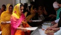 Indian sikh women take their lunch inside their temple during Baisakhi celebration in Mallorca