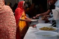 Indian sikh women take their lunch in their temple during Baisakhi celebration in Mallorca