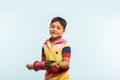 Indian small kid or boy holding spindal or chakri on Makar Sankranti festival, ready to fly Kite Royalty Free Stock Photo