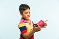 Indian small kid or boy holding spindal or chakri on Makar Sankranti festival, ready to fly Kite Royalty Free Stock Photo