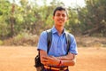 Indian smart boy arms crossed looking at camera in backyard Royalty Free Stock Photo