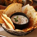 indian snack, masala papad and crispy naan bread in a basket with yogurt raita Royalty Free Stock Photo