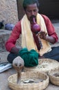 Indian snake charmer with cobra. Hampi, India