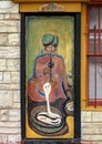 Indian snake charmer painting on an outside door at the Cosmic Cafe on Oak Lawn in Dallas, Texas.