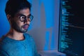 Indian software development working on coding computer screen and flowchart at night in modern office