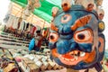 Indian souvenir market with old wooden mask of Mahakala deity, popular in Hinduism and Buddhism