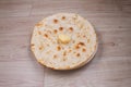 Indian special flat bread also known as butter tandoori roti or naan, served in a white ceramic quarter plate Royalty Free Stock Photo