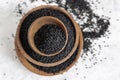 Indian spice Black cumin nigella sativa or kalonji seeds in wooden bowls top view Royalty Free Stock Photo