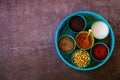 Indian spice box on wooden background with copy space,Cardamom, turmeric, chilli powder, salt,mustard seeds,cumin, selective focus Royalty Free Stock Photo