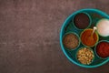 Indian spice box on wooden background with copy space,Cardamom, turmeric, chilli powder, salt,mustard seeds,cumin, selective focus Royalty Free Stock Photo