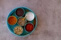 Indian spice box on wooden background with copy space,Cardamom, turmeric, chilli powder, salt,mustard seeds,cumin, selective focus Royalty Free Stock Photo