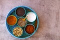 Indian spice box on wooden background with copy space,Cardamom, turmeric, chilli powder, salt,mustard seeds,cumin, selective focus Royalty Free Stock Photo