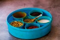 Indian spice box on wooden background with copy space,Cardamom, turmeric, chilli powder, salt,mustard seeds,cumin, selective focus Royalty Free Stock Photo