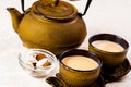 Indian spiced tea with milk. Teapot and sweets