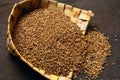 Indian spices, ajowan bishop seed in winnowing basket , India Royalty Free Stock Photo