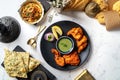 Indian spices barbecue Murgh Tandoori or tandoori chicken with raita, lime, chapati and onion rings served in a dish isolated on Royalty Free Stock Photo