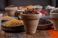 Indian spices collection, dried colorful condiment, nuts, pods and seeds and another spices in clay bowls Royalty Free Stock Photo