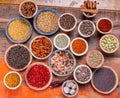 Indian spices collection, dried colorful condiment, nuts, pods and seeds and another spices in clay bowls Royalty Free Stock Photo