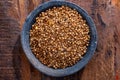 Indian spices collection, dried coriander seeds in clay bowl top view
