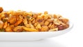 Indian spicy snacks Namkeen - All in one` in white ceramic oval bowl, having peanut, corn flakes, sweet pea, pulses, cash