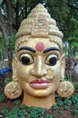 Indian staue of gilded head with third eye chakra