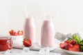 Indian strawberry lassi or milkshake in bottle on white .