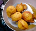 An Indian Street Food Group of Frying Pakora or Bhajiya in oil