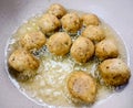 An Indian Street Food Group of Frying Pakora or Bhajiya in oil