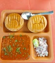 Indian street food photography, toasted bread buns and vegetable curry with onions in a plate, tasty vegetarian dishes background Royalty Free Stock Photo