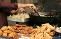 Indian street food vendor make popular samosas on a busy road