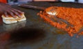 Indian street food vendor making pav baji or vada pav