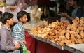 Indian street food vendor sell popular samosas on a busy road