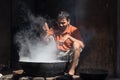 Indian street vendor make fast food in old wok the fire . Pushkar, India