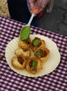 Indian street vendor making pani puri snack in outdoors