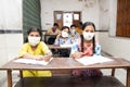 Indian Students Studying In Classroom Wearing Mask And Social Distancing, school reopen during covid19