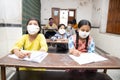 Indian Students Studying In Classroom Wearing Mask And Social Distancing, school reopen during covid19