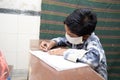 Indian Students Studying In Classroom Wearing Mask And Social Distancing, school reopen during covid19