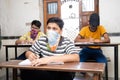 Indian Students wearing face masks maintaining social distancing at a classroom as school reopen during covid19