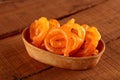 Indian Sweet Jalebi in a handmade pottery bowl on wooden background Royalty Free Stock Photo