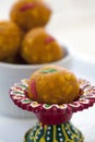 Indian sweet laddu in a colorful red dish