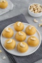 Indian sweets Besan Laddu or Laddoo on a plate on a concrete bacground. Roasted chickpea flour with ghee and sugar. Selective Royalty Free Stock Photo