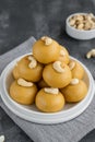 Indian sweets Besan Laddu or Laddoo on a plate on a concrete bacground. Roasted chickpea flour with ghee and sugar. Selective Royalty Free Stock Photo
