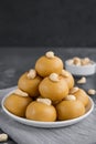 Indian sweets Besan Laddu or Laddoo on a plate on a concrete bacground. Roasted chickpea flour with ghee and sugar. Royalty Free Stock Photo