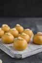 Indian sweets Besan Laddu or Laddoo on a wooden board on a concrete bacground. Roasted chickpea flour with ghee and sugar. Royalty Free Stock Photo