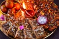 Diwali prasad thaali with earthen lamp diya and silver coin Royalty Free Stock Photo