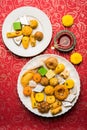 Indian sweets or Mithai for diwali festival with oil lamp or diya and gift box Royalty Free Stock Photo