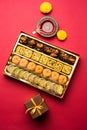 Indian sweets or Mithai for diwali festival with oil lamp or diya and gift box Royalty Free Stock Photo